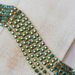 2.4 mm rhinestone chain with Emerald AB Preciosa crystals in raw setting x 20 cm
