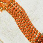 2.4 mm rhinestone chain with Orange Opaque in raw setting x 40 cm
