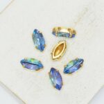 5x10 mm Navette glass cabochon Light Sapphire Rainbow with gold-colored claw x 6 pc(s)