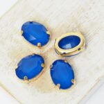10x14 mm oval glass cabochon Capri Blue Matt with gold-colored claw x 4 pc(s)