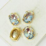 10x14 mm oval glass cabochon Blue Lagoon AB with gold-colored claw x 4 pc(s)