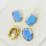 10x14 mm oval glass cabochon Sapphire Opal AB with gold-colored claw x 4 pc(s)