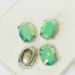 10x14 mm oval glass cabochon Caribbean Sea Opal AB with silver-colored claw x 4 pc(s)