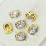 8x10 mm oval glass cabochon Blue Lagoon AB with gold-colored claw x 6 pc(s)