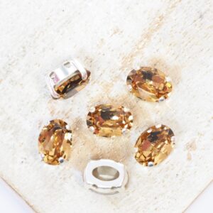 6x8 mm Preciosa Fancy Oval Cabochon Light Colorado Topaz in Silver-colored setting x 6 pc(s)