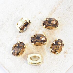 6x8 mm Preciosa Fancy Oval Cabochon Smoked Topaz in Gold-colored setting x 6 pc(s)
